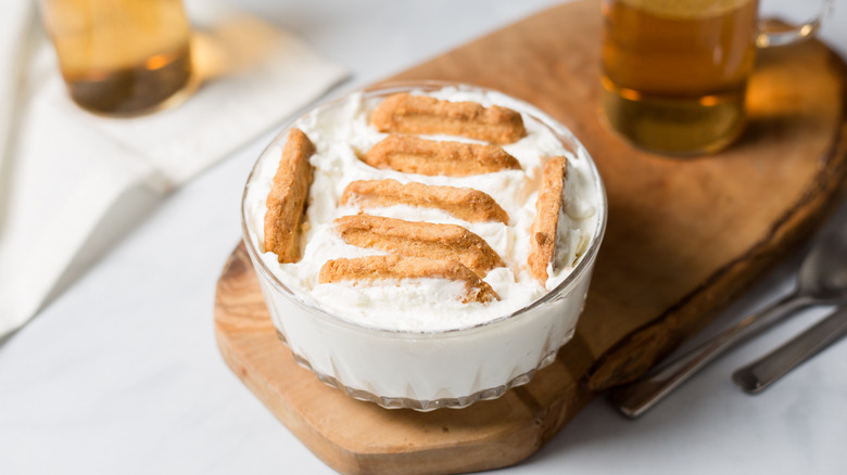 yogurt with cookies on table