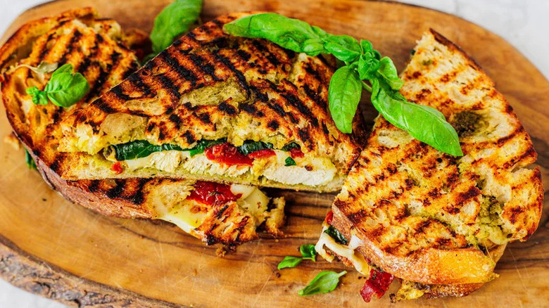 Chicken Pesto Panini on wooden cutting board