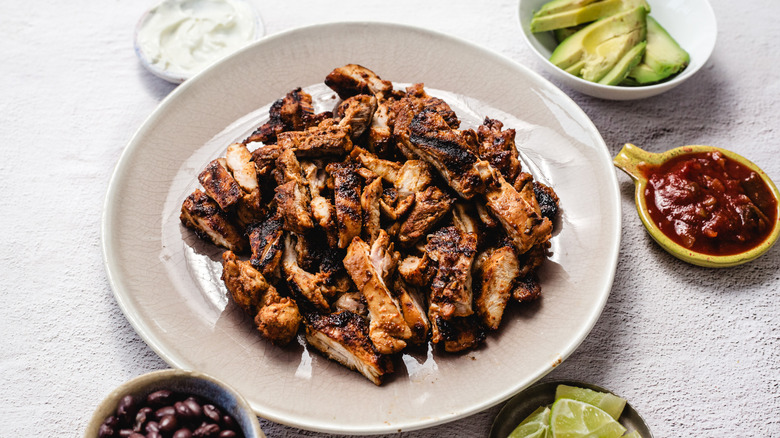 Chipotle honey chicken on plate with toppings