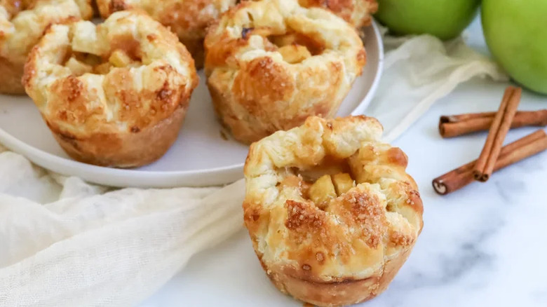 Copycat Starbucks Baked Apple Croissant with more pastries and cinnamon in the background