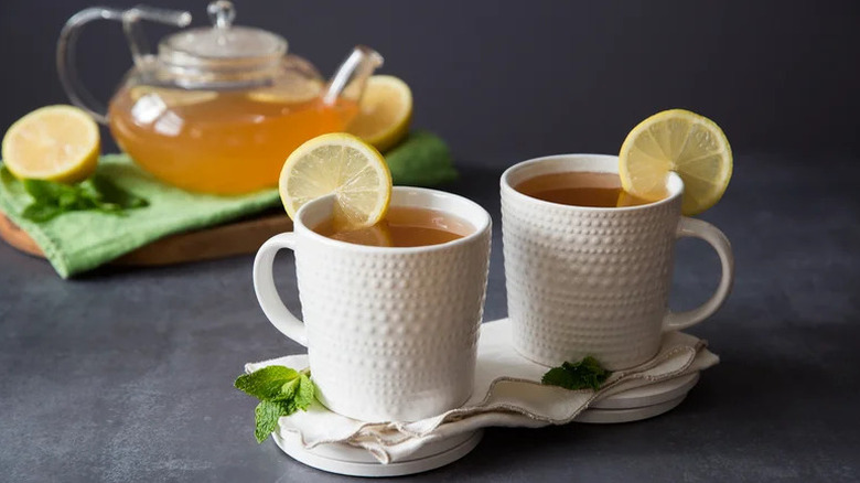 Copycat Starbucks Medicine Ball drink in white mugs with lemo