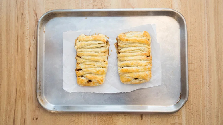 Two pieces of Elevated Panera Bread Pecan Braid on a tray