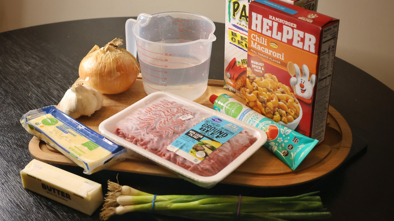Elevated Hamburger Helper ingredients laid out on cutting board