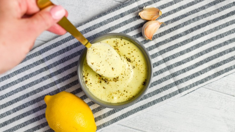 bowl of garlic lemon aioli with spoon