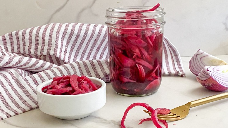 pickled onions in jar and in white dish