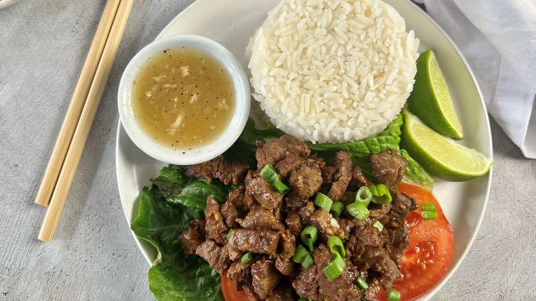 lok lak beef stir fry with salad and rice