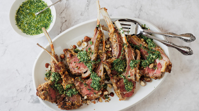 lamb chops with mint pesto on white platter