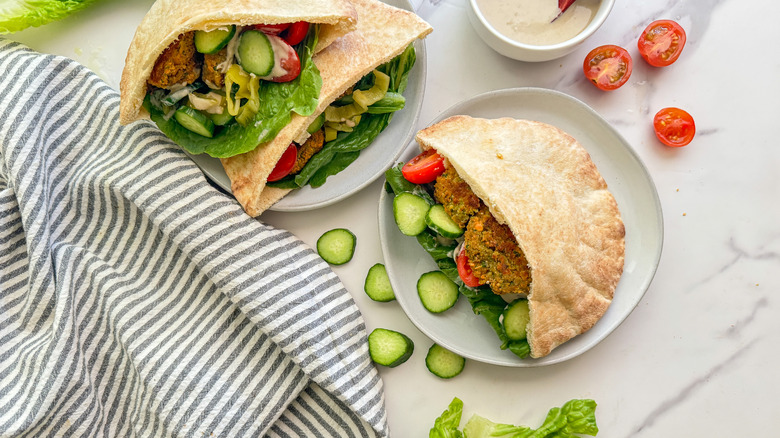 pita sandwiches on two plates