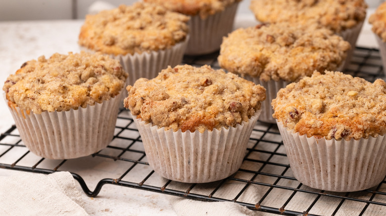 Cinnamon crumble apple pecan muffins on wire rack