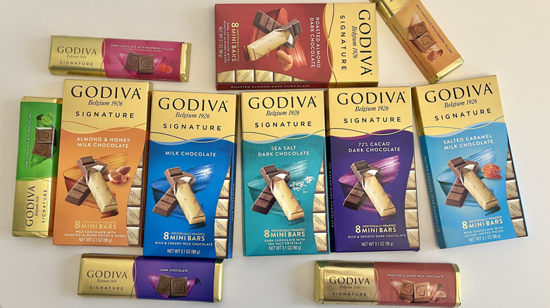 Godiva bar chocolates are displayed on a table.