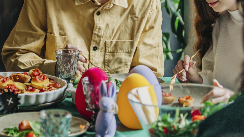 Family eating dinner around Easter-themed table