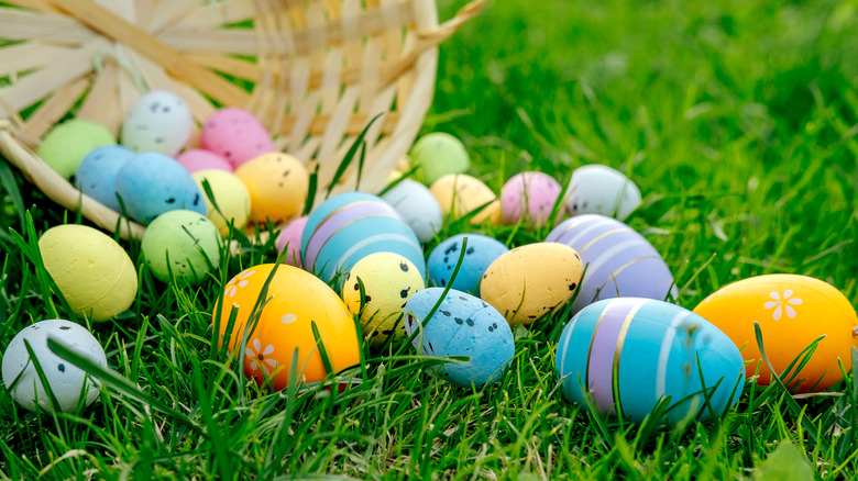 easter basket with decorated eggs spilling out