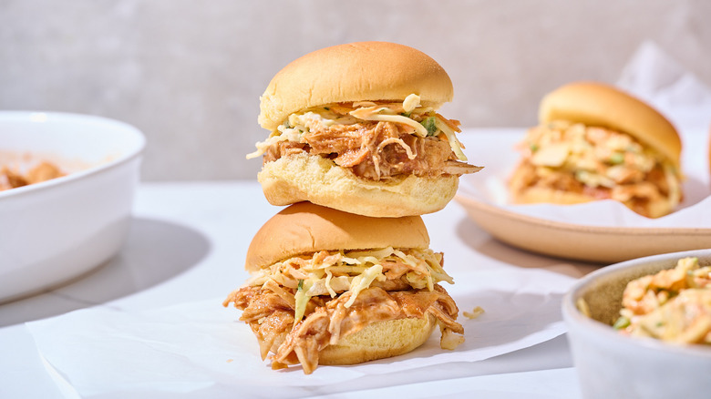 Pulled chicken sliders on a table