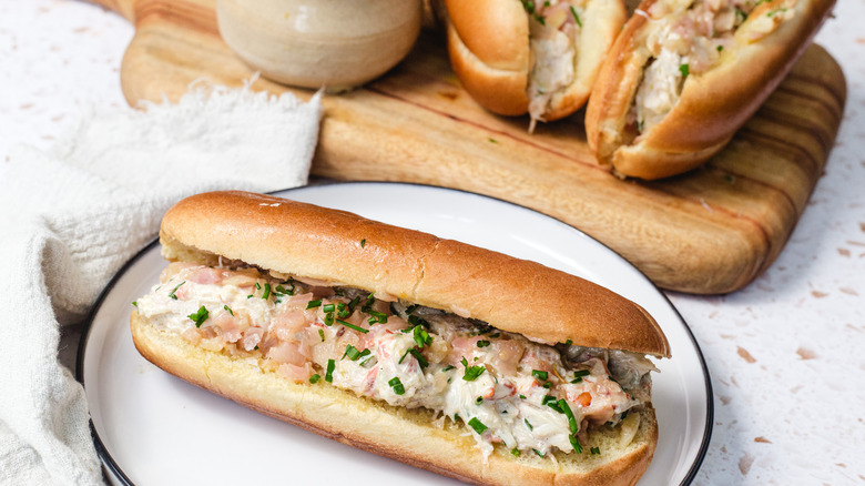Crab roll in front of board with crab rolls and napkin