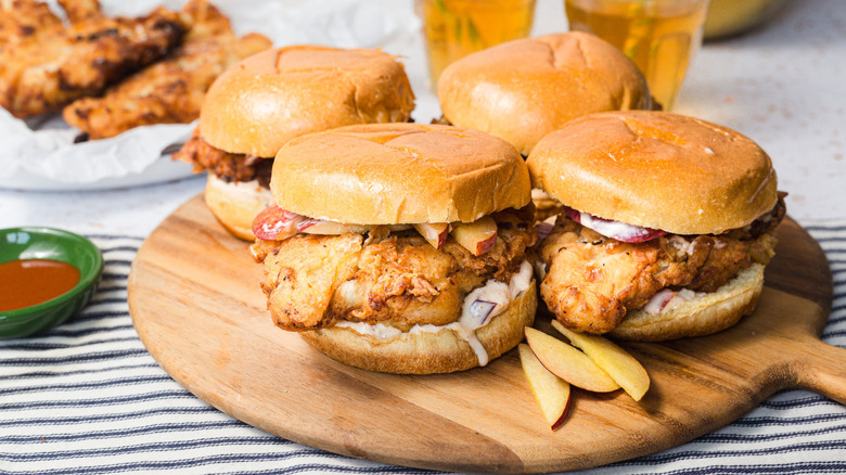 Four sandwiches on wooden board