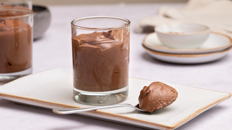 Chocolate mousse in serving cup and on spoon
