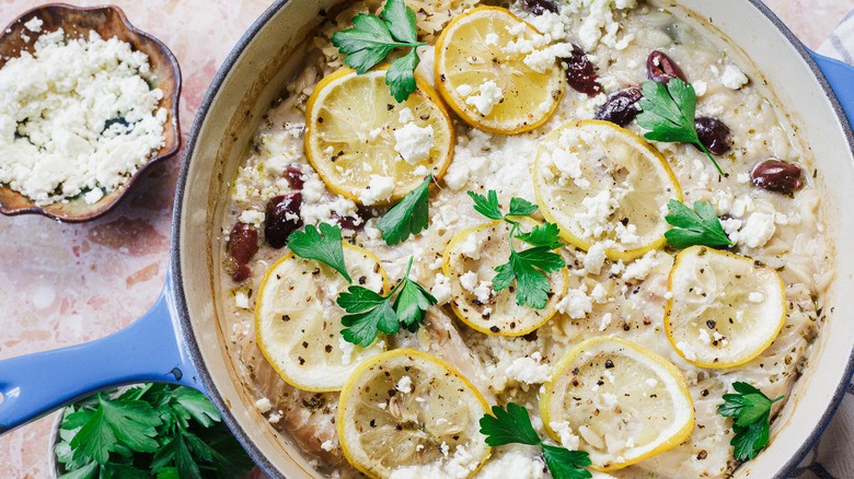 Large blue pot of orzo and fish with feta and parsley