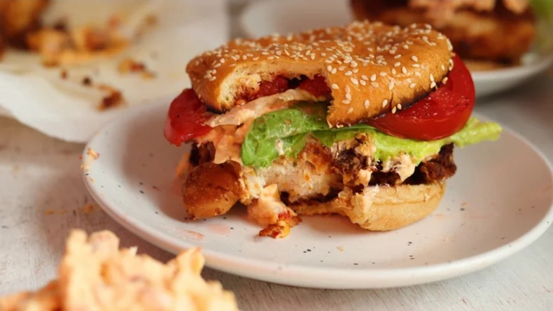 Pimento cheese-stuffed chicken sandwich with bite taken out