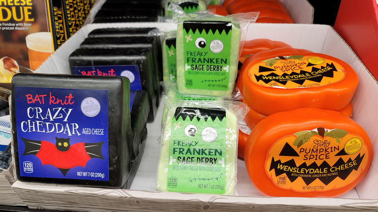 Three types of Halloween-themed cheeses on Aldi's store shelf