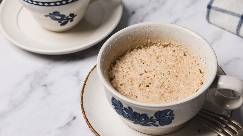 Two vanilla mug cakes in white cups