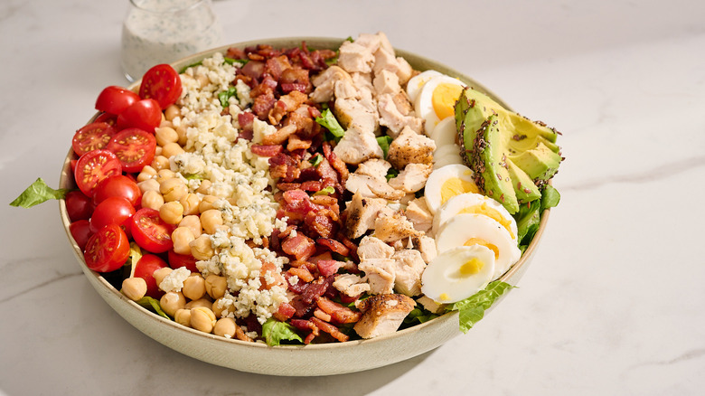 cobb salad in a large bowl on a table