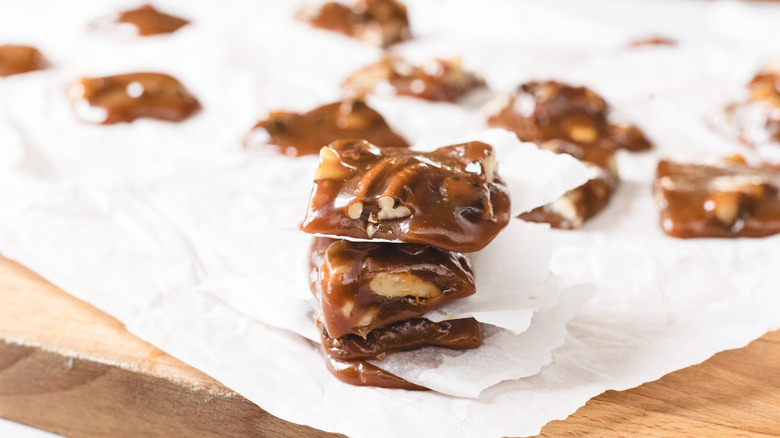 Stack of three pieces of candy over parchment paper