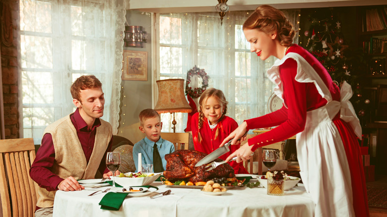 Family having a holiday dinner together, 1950s retro style image