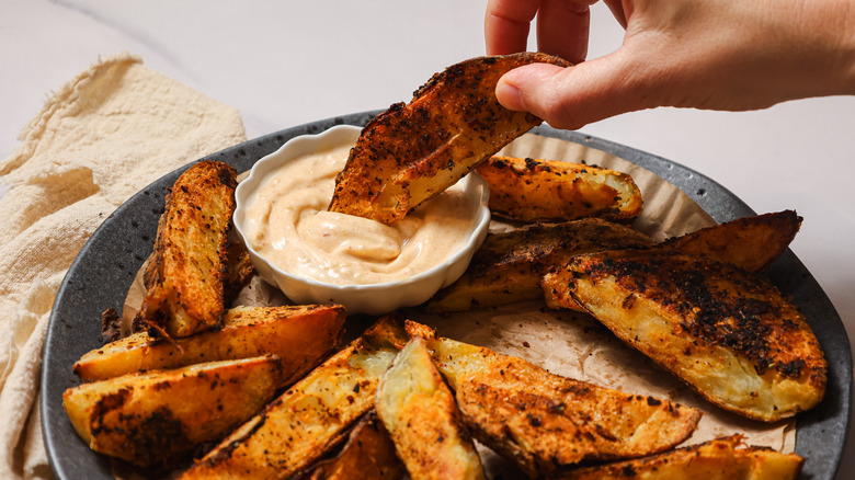 Dipping steak fries into aioli