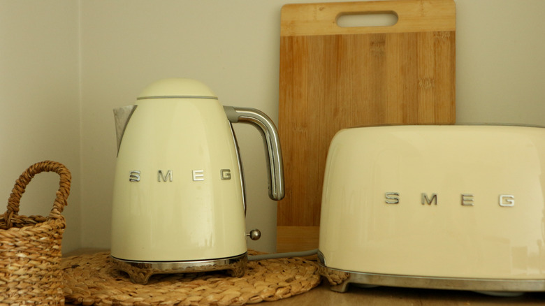 Cream colored Smeg electric kettle and toaster on counter