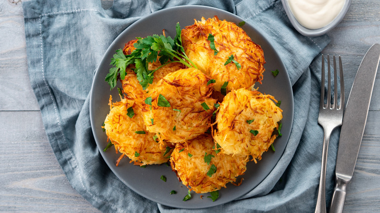 plate of potato latkes with sour cream