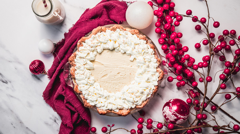 Old-fashioned eggnog pie on marble counter with Christmas decorations