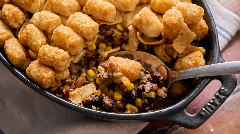 Spoon scooping into tater tot cowboy casserole
