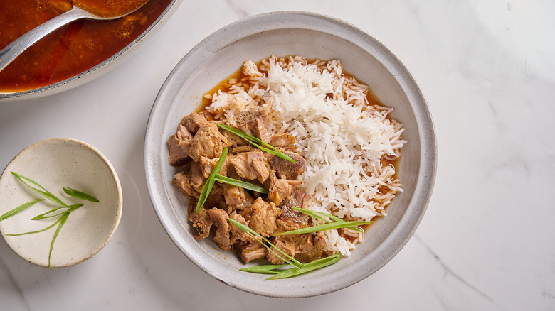 bowl with rice and pulled pork in sauce