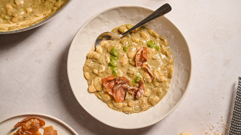 pesto beans in a bowl with a spoon