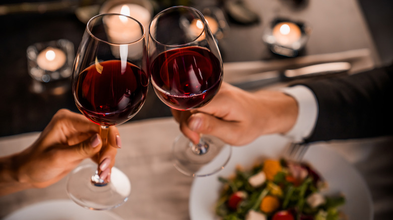 clinking glasses over meal