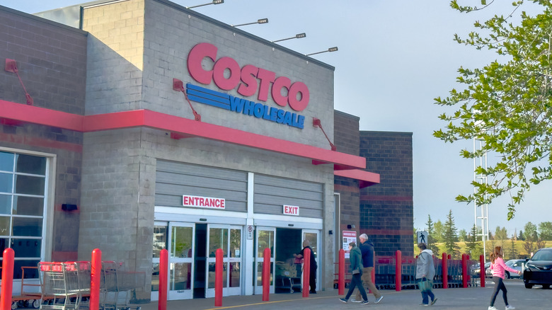 Outside view of shoppers entering Costco store.