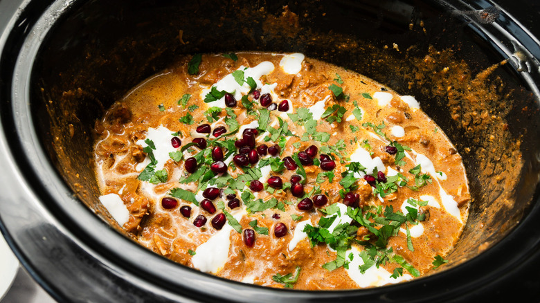 Chicken Tikka Masala with pomegranate seeds and cilantro in slow cooker