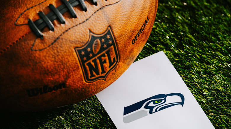 Football on turf with Seattle Seahawks logo on paper