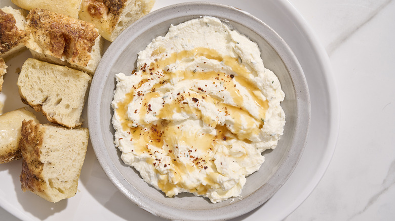 hot honey cheese dip on a platter with bread