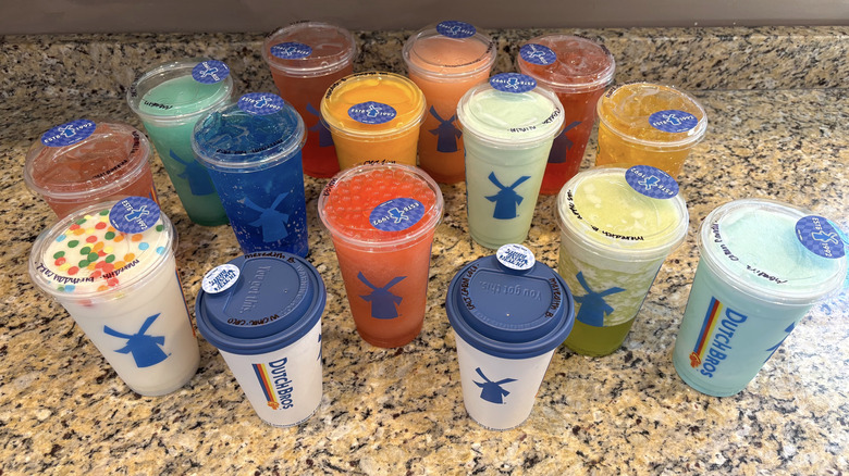 A variety of Dutch Bros drinks on a marble countertop