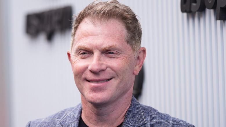 Bobby Flay smiles at an event