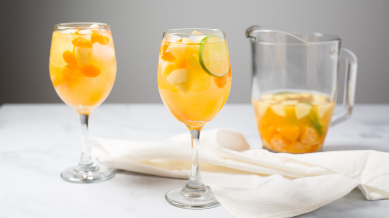 Citrus white wine sangria glasses on table
