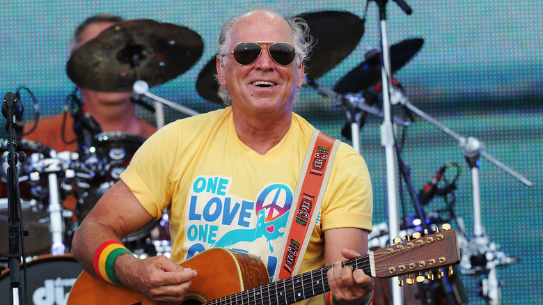 Jimmy Buffett playing guitar onstage