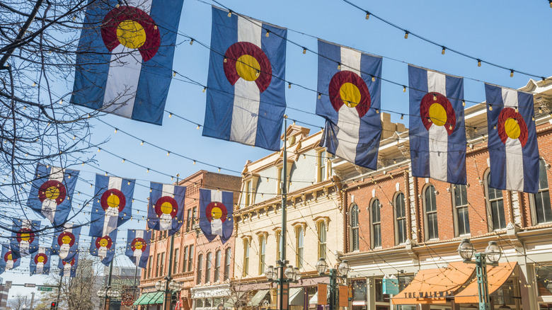 Colorado flags hanging across the road in a historic district