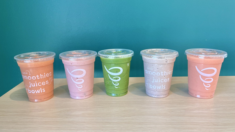 Five Jamba smoothies lined up on a table