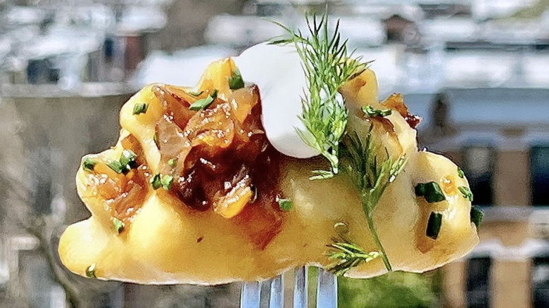 pierogi on fork in front of city
