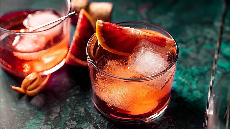 Negroni sbagliato cocktail in glasses with ice cubes and slices of blood orange