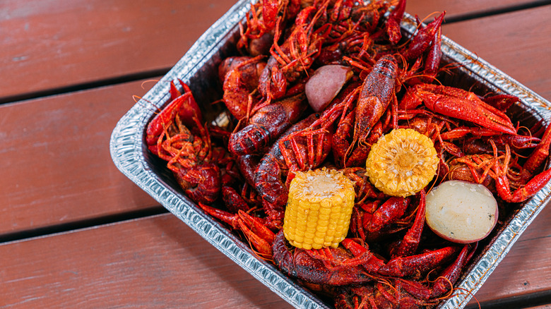 Seafood boil with corn in aluminum tray