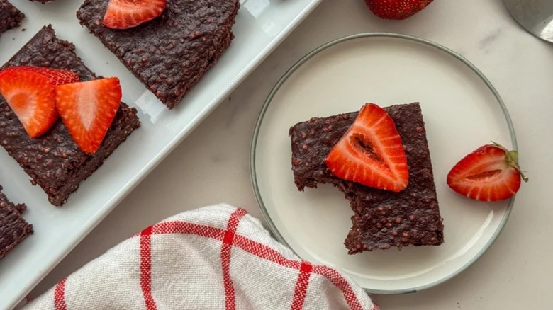Quinoa Cacao Brownies on white plate with strawberry slice