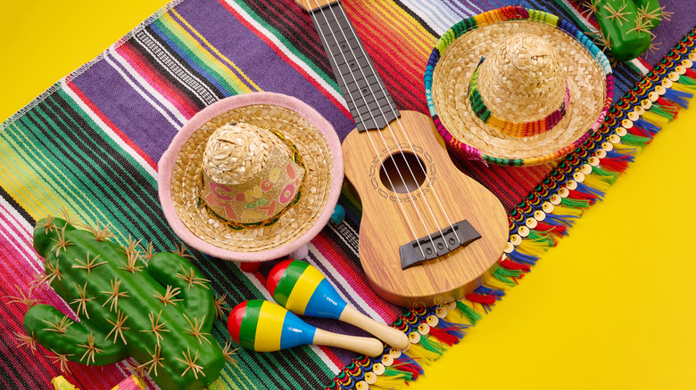 Mexican-inspired party objects on a yellow background